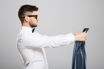 Young man holding jacket