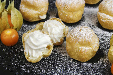 Delicious profiteroles with cream and chocolate glaze