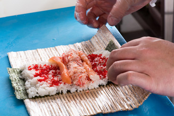 Preparing sushi rolls