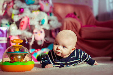 Obraz premium The small boy lies on the carpet