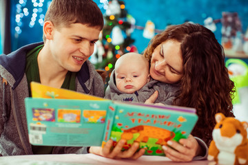 Fototapeta premium The mother,father and son reading a book