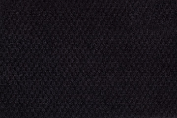 Black background from soft fleecy fabric closeup. Texture of textiles macro