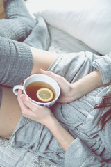 Cozy winter concept with girl drinking hot tea