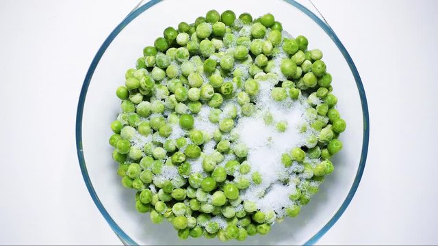 Time-lapse defrost green peas view from above