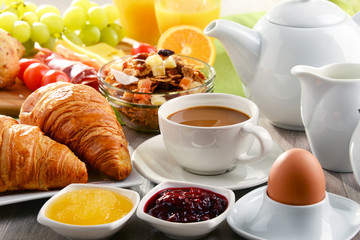 Breakfast served with coffee, juice, egg, and rolls