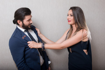 Beautiful couple elegantly dressed teasing each other