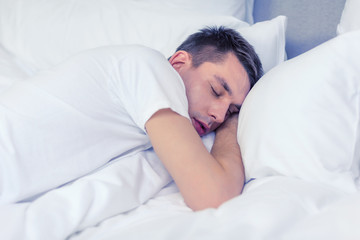 Fototapeta na wymiar handsome man sleeping in bed