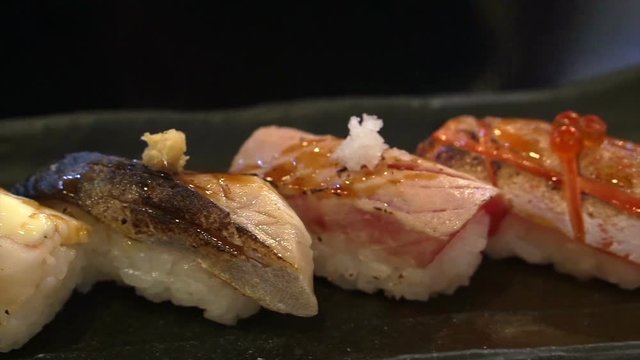 Aburi nigiri set or seared sushi set. Japanese food, raw fish with fast fire burn