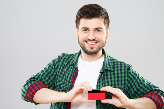 Young man holding red credit card