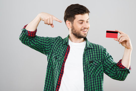 Man pointing at red credit card