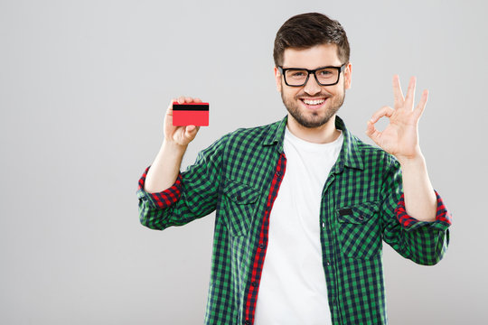 Man holding credit card and showing ok