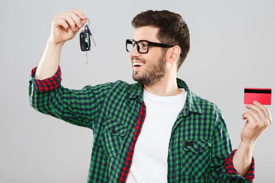 Man holding red credit card and keys