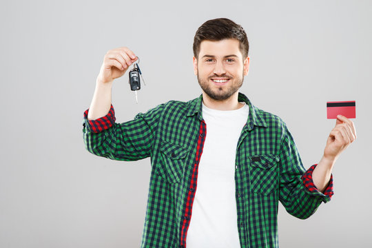 Man holding red credit card and car keys