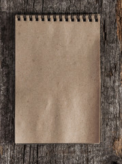  spiral blank notebook with pencil on wood desk background
