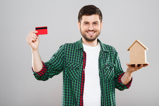 Man holding red credit card and money box