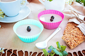 Cup of coffee, jelly, grain small loafs on a table