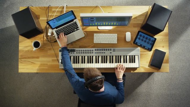 Top View of a Musician Creating Music at His Studio, Playing on a Musical Keyboard. His Studio is Sunny and Pleasant Looking. Shot on RED Cinema Camera in 4K (UHD).
