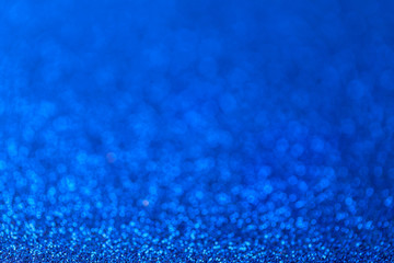 Blue sparkling background from small sequins, closeup. Brilliant backdrop