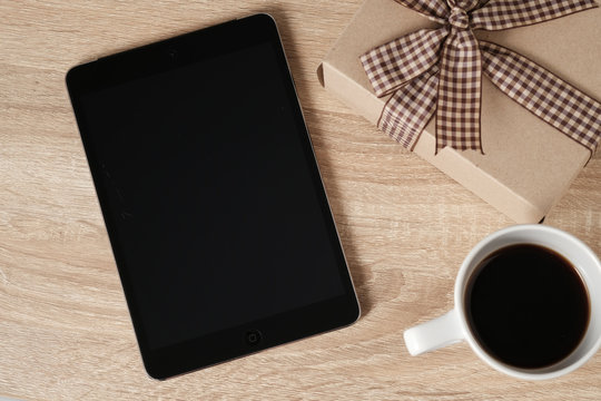 Blak teblet screen and coffee from top view