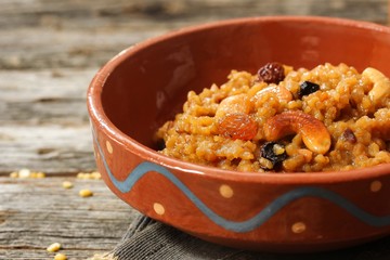 Sweet Pongal or Chakkara pongal on traditional clay pot, selective focus