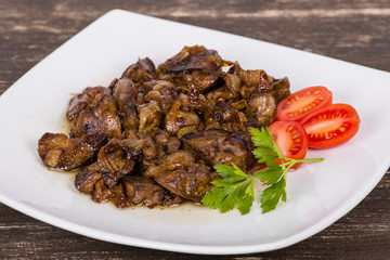 Chicken livers in a creamy sauce with onion on white plate