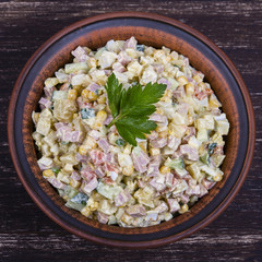 Russian traditional salad olivier with pea in the plate.