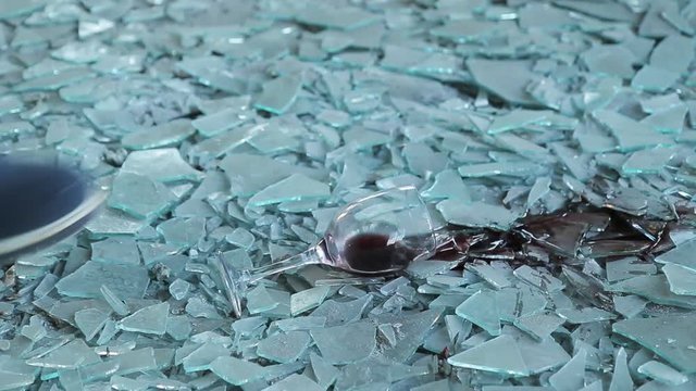 A glass of wine. A glass of wine, standing on broken glass, tilt the toe of the Shoe
