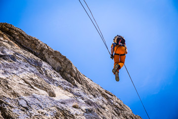 guy climber down a cliff on a rope