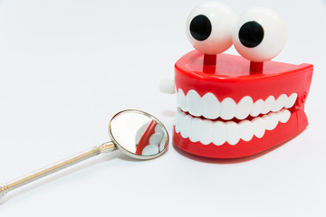 Dental care concept on white background with mirror dentist tool