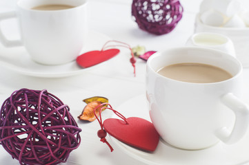 Romantic breakfast with couple white cups of coffee on white