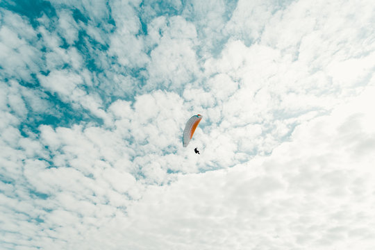 Hang glider and cloudy sky 