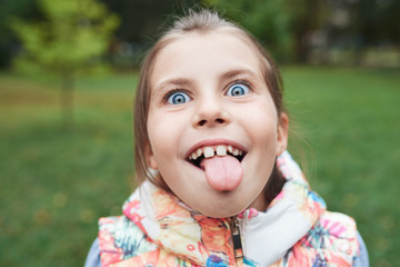 Cute little girl sticking out her tongue