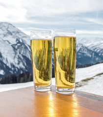 Glass of the fustrian beer against snow mountains a valley of the Zillertal - Mayrhofen, Austria - 133114449