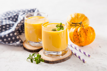 pumpkin smoothie in a glass on a table, selective focus, copy space