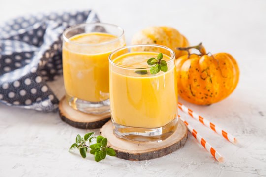 pumpkin smoothie in a glass on a table, selective focus, copy space