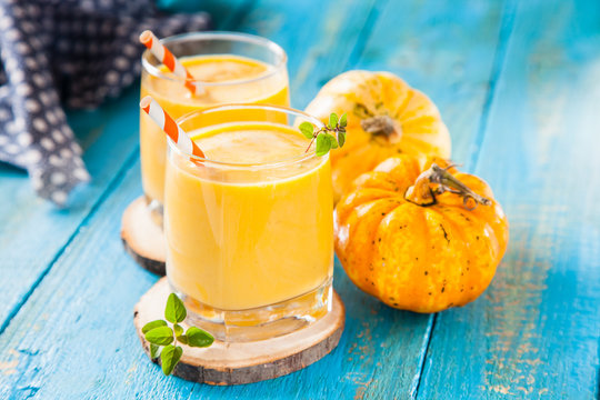 pumpkin smoothie in a glass on a table, selective focus, copy space