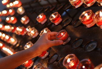 red candles lighted and the hand of the child