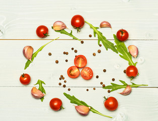 arugula leaves, garlic and tomatoes