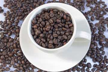 Coffee beans in coffee cup isolated on white
