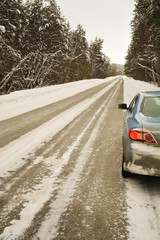 passenger car on the side of the road in the winter