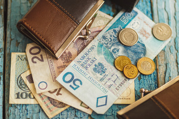 Polish zloty with a wallet on the wooden background
