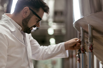 Handsome man working as a brewer