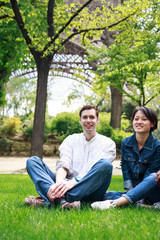 Obraz premium Multi-ethnic Couple Having Fun In Park Near Eiffel