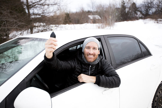 Portrait Of Handsome Man In Car In Winter