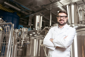 Smiling man posing with brewing mechanisms