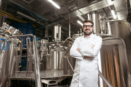 Joyful man posing with brewing mechanisms