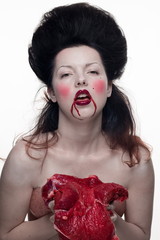 emotional brunette actress in the role of a vampire with blood drops on his face and a piece of...