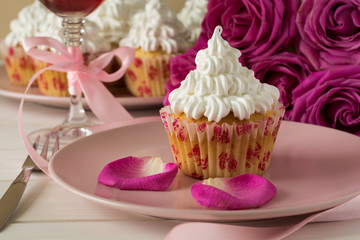 Sweet romantic cupcakes for Valentine's Day on a white wooden background. Selective focus