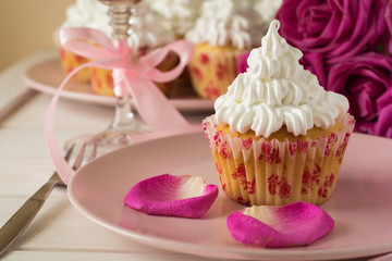 Sweet romantic cupcakes for Valentine's Day on a white wooden background. Selective focus