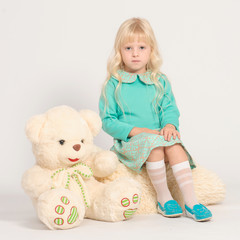 Young blondy girl with teddy bear